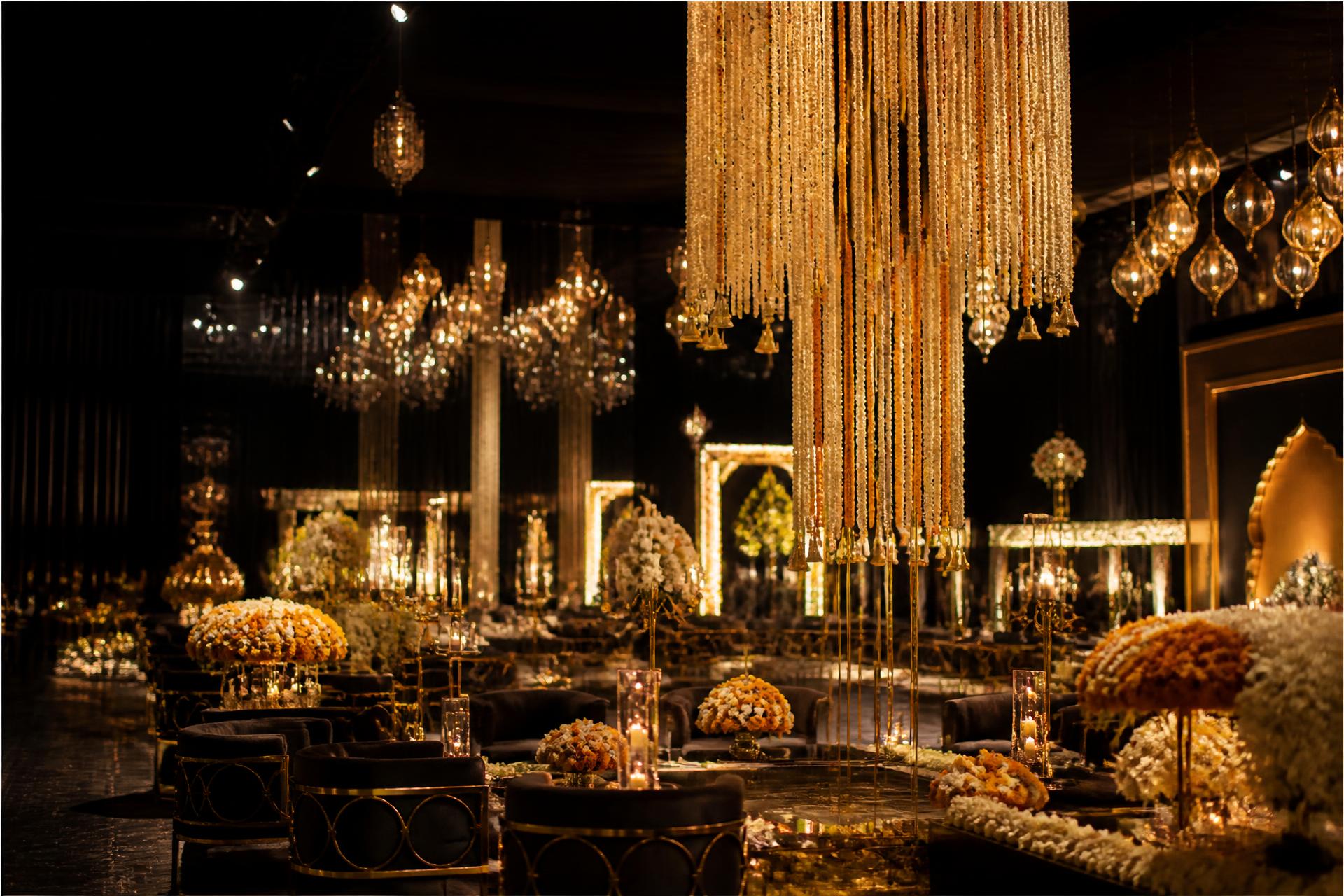 Candlelit luxury wedding reception hall with gold chandeliers
